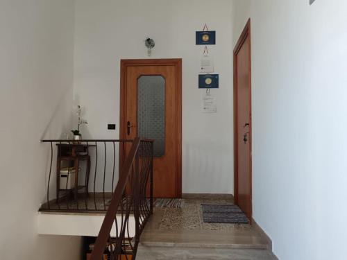 a hallway with a wooden door and a stair case at La Suite Di Rita in Giulianova
