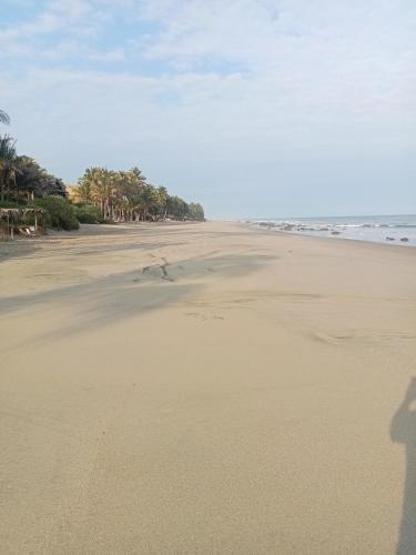 a shadow of a person standing on a beach at Villa Naylamp loft en las pocitas in Máncora