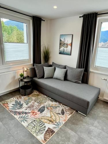 a couch in a living room with two windows at Juwel 02 in Trieben