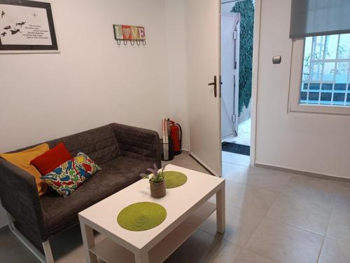 a living room with a couch and a coffee table at Wendy House - Central Sofia - 3BRDR - Private Courtyard - 5 min to Vitosha blvd in Sofia