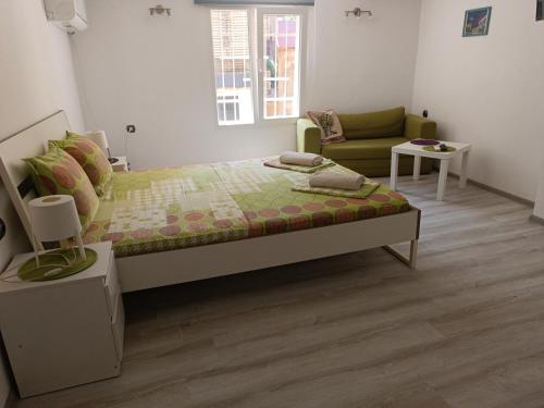 a bedroom with a bed and a couch at Wendy House - Central Sofia - 3BRDR - Private Courtyard - 5 min to Vitosha blvd in Sofia