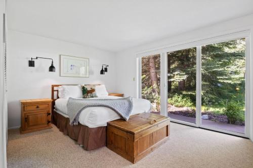 a bedroom with a bed and a large window at RMR: Four Seasons II 1 Condo in Teton Village in Teton Village