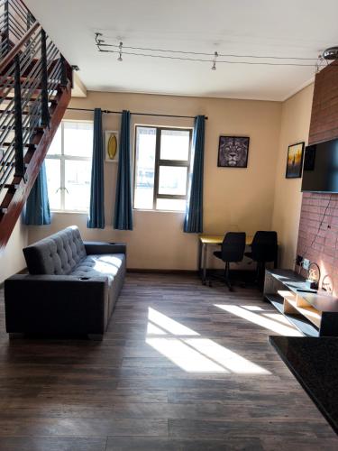 a living room with a couch and a table at Mapungubwe Apartments in Johannesburg