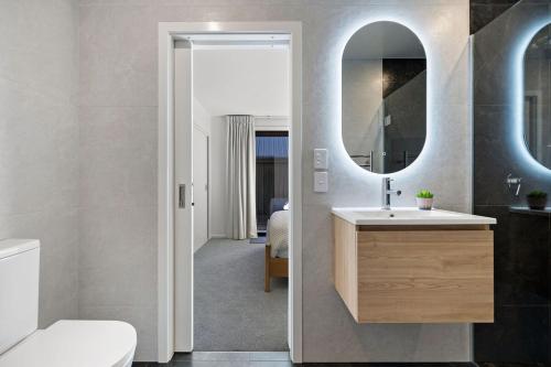 a bathroom with a sink and a mirror at Alpenglow Lodge with steam sauna in Queenstown