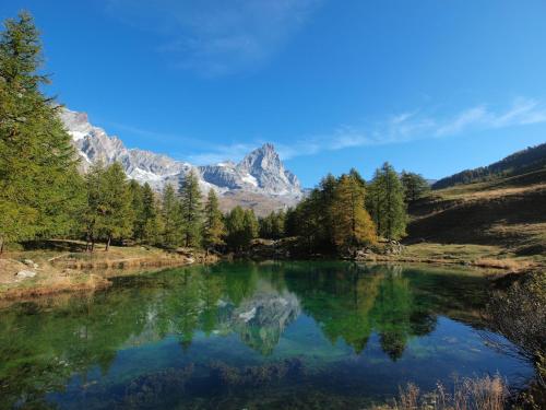 a mountain reflection in a lake in the mountains at Apartment Breuil-Cervinia near Ski Lift in Breuil-Cervinia