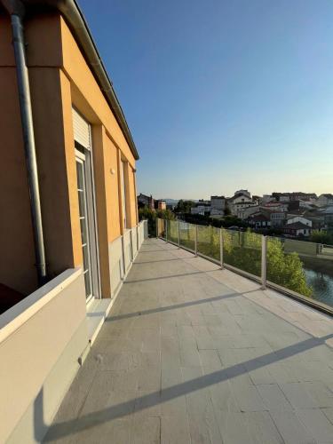 a balcony of a building with a view of a city at Apartamento Paseo Malecón Planta 2 in Monforte de Lemos