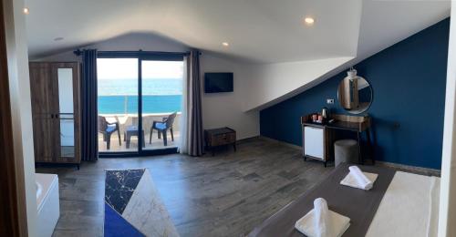 a living room with a view of the ocean at Olimpia Hotel in Fethiye