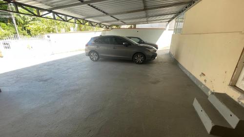 a car parked inside of a parking garage at Loft novíssimo com banheira imersão aquecida a 5min da Vila Germânica in Blumenau