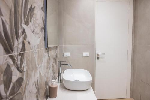 a bathroom with a white toilet and a sink at Bed and Breakfast Al Portanova in Reggio Calabria