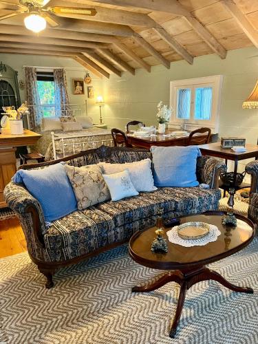 a living room with a couch and a table at Historic Devoe House-Walk to Downtown Arts and Restaurants in Wausau