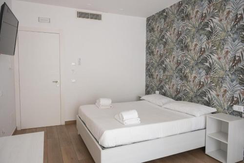 a bedroom with a bed and a wall mural at Bed and Breakfast Al Portanova in Reggio Calabria