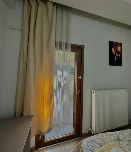 a bedroom with a window with a curtain at Link Taksim Hotel in Istanbul