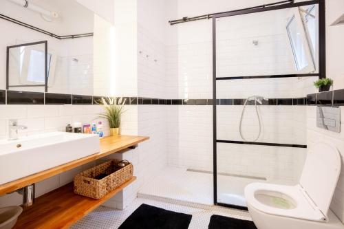 a bathroom with a sink toilet and a shower at The City Gem in Bratislava