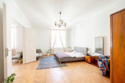 a bedroom with a bed and a chandelier at The City Gem in Bratislava