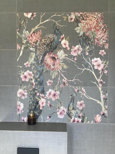 a painting of birds and flowers on a wall at Apartamenty iGrażka in Kudowa-Zdrój