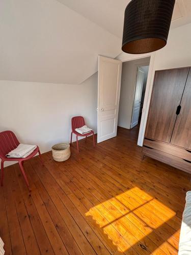 a room with two chairs and a rug on a wooden floor at Villa Waterfront View Chausey in Granville