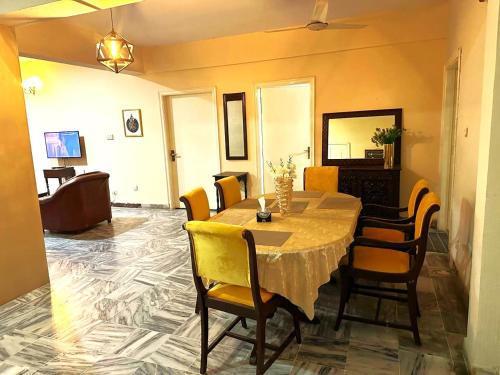 a dining room with a table and chairs at Diplomatic Enclave Islamabad in Islamabad
