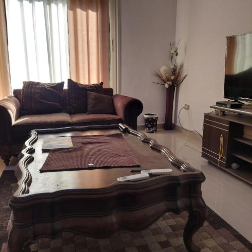 a living room with a couch and a coffee table at El dakroury king mariout villa in Naj‘ al Aḩwāl