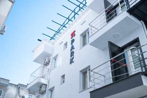 a white building with a sign on it at PP Hotel in Burunabat
