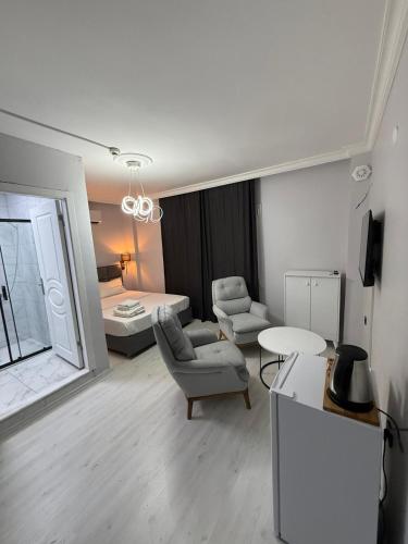 a living room with a bed and a couch and a chair at PP Hotel in Burunabat