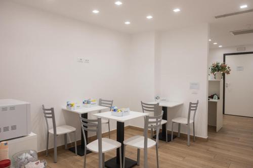 a dining room with white tables and chairs at Bed and Breakfast Al Portanova in Reggio Calabria