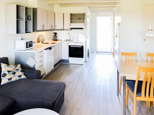 a kitchen and living room with a couch and a table at 6 person holiday home in Hadsund in Hadsund
