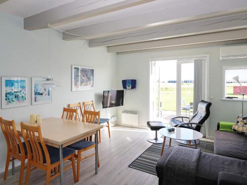 a living room with a table and a couch at 6 person holiday home in Hadsund in Hadsund