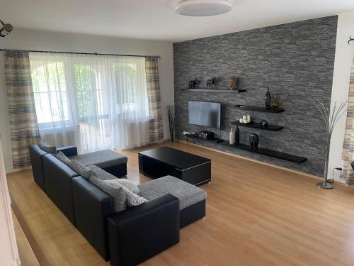 a living room with a couch and a tv at Rodinný dům Divišov u Benešova, Na Spravedlnosti 276 in Golčŭv Jeníkov