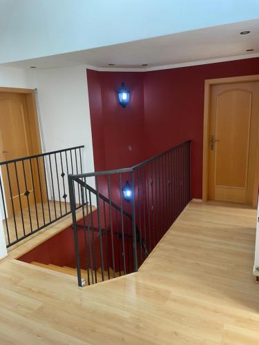 an empty room with a staircase with red walls at Rodinný dům Divišov u Benešova, Na Spravedlnosti 276 in Golčŭv Jeníkov