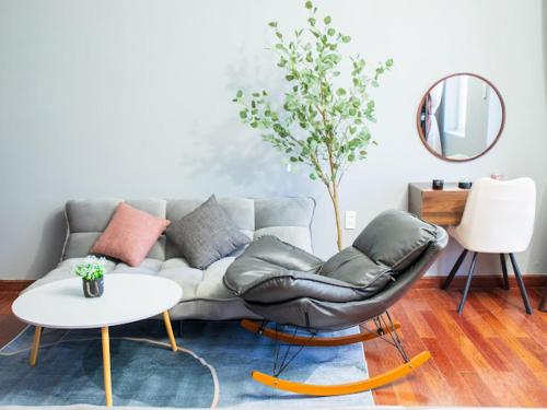 a living room with a couch and a table at Green House - Căn hộ có bếp riêng in Da Lat