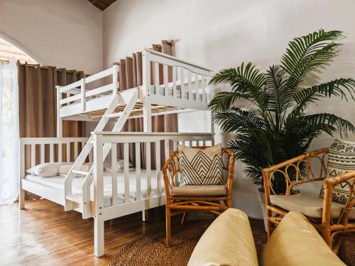 a white bunk bed in a living room with a plant at Manawari Beach Resort in Caliclic