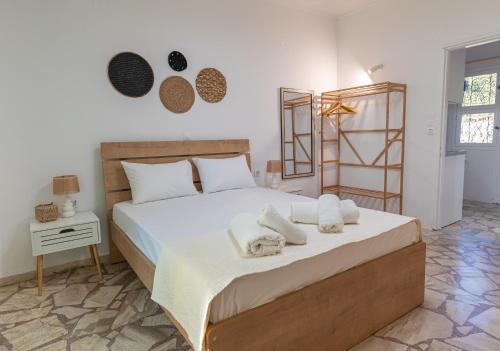 a bedroom with a large bed with towels on it at Kalamis Seaview2 in Samos