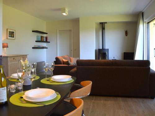 a living room with a table and a couch at Family Apartment Bouillon and Semois River in Gros-Fays