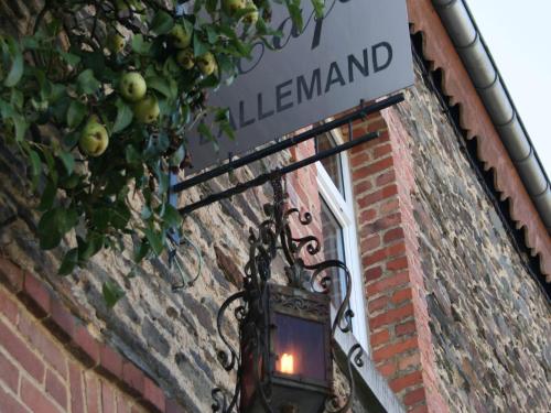 a light on the side of a brick building with a sign at Family Apartment Bouillon and Semois River in Gros-Fays