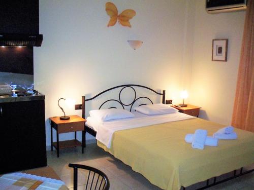 a bedroom with a bed with two towels on it at Four Seasons Studio in Asprovalta
