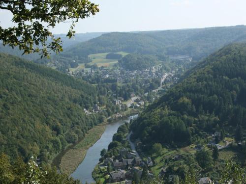 a river flows through a valley in the mountains at Family Apartment Bouillon and Semois River in Gros-Fays
