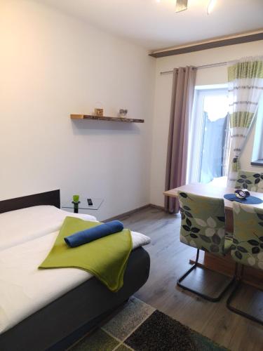 a bedroom with a bed and a table and a window at Bergliesal in Wildalpen