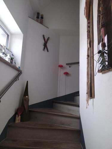a room with stairs and a clock on the wall at Bergliesal in Wildalpen