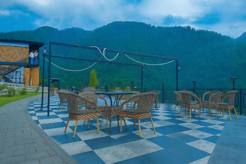a group of chairs and tables on a patio at Nature on the Rocks Glamping Resort in Shivpuri