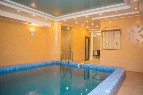 a large swimming pool in a room with at Hotel Status in Vinnytsya