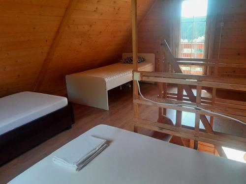a room with two beds and a table and a window at Agroturystyka u Krystyny in Rybczewice