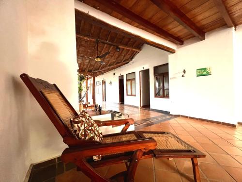 a room with a rocking chair and a hallway at Hotel Villa de Mompox in Mompos