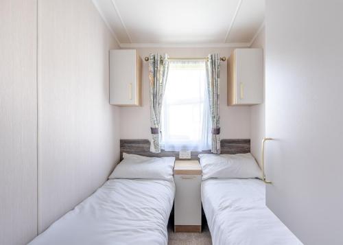 Ένα ή περισσότερα κρεβάτια σε δωμάτιο στο Coldstream Holiday Park