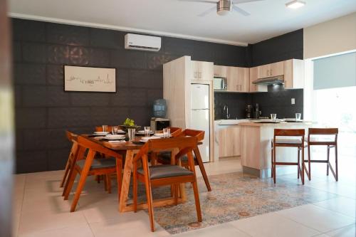a kitchen and dining room with a table and chairs at Hacienda la floresta in Tulum
