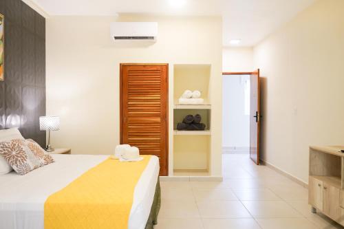a bedroom with a bed and a closet with towels at Hacienda la floresta in Tulum