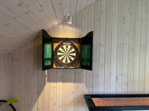 a dart board on the wall of a building at Cozy holiday home - spa, hot tub and play room - close to Marielyst square in Bøtø By