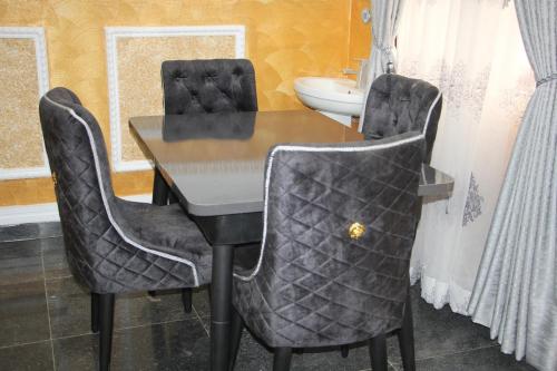 a dining room table with two chairs and a sink at A Luxury 3 bedroom bungalow in Owerri