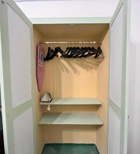 a walk in closet with shelves and a door at POSITANO CENTRAL HOUSE free wi-fi and air condition in Positano