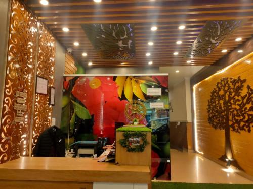 a restaurant with a table and a vase of bananas at HOTEL GRAND HILL ,MALL ROAD ,Mcleodganj in Dharmsala