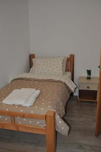 a bedroom with a bed with a wooden frame at The Barn at Cae Bach in Gwalchmai